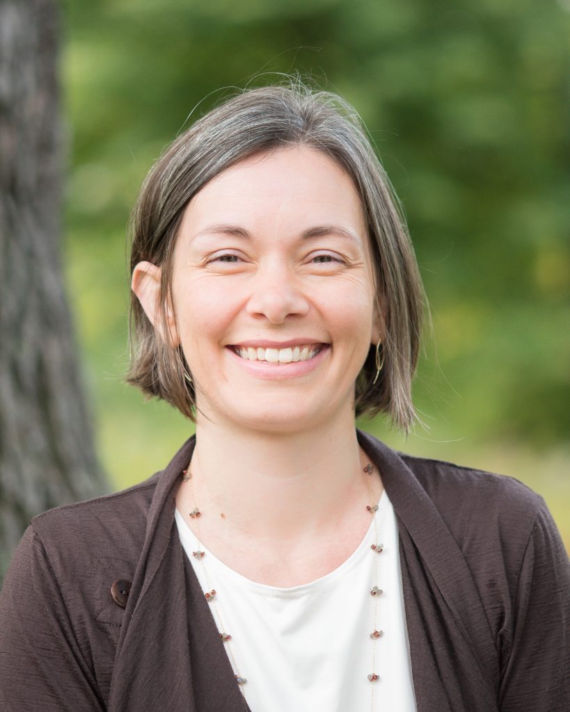 woman with brown hair, smiling