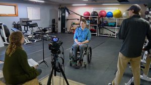 man in wheelchair being interviewed