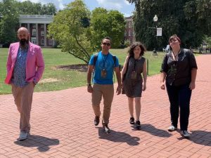 Robin DeRosa and three others walk on the Plymouth State University campus