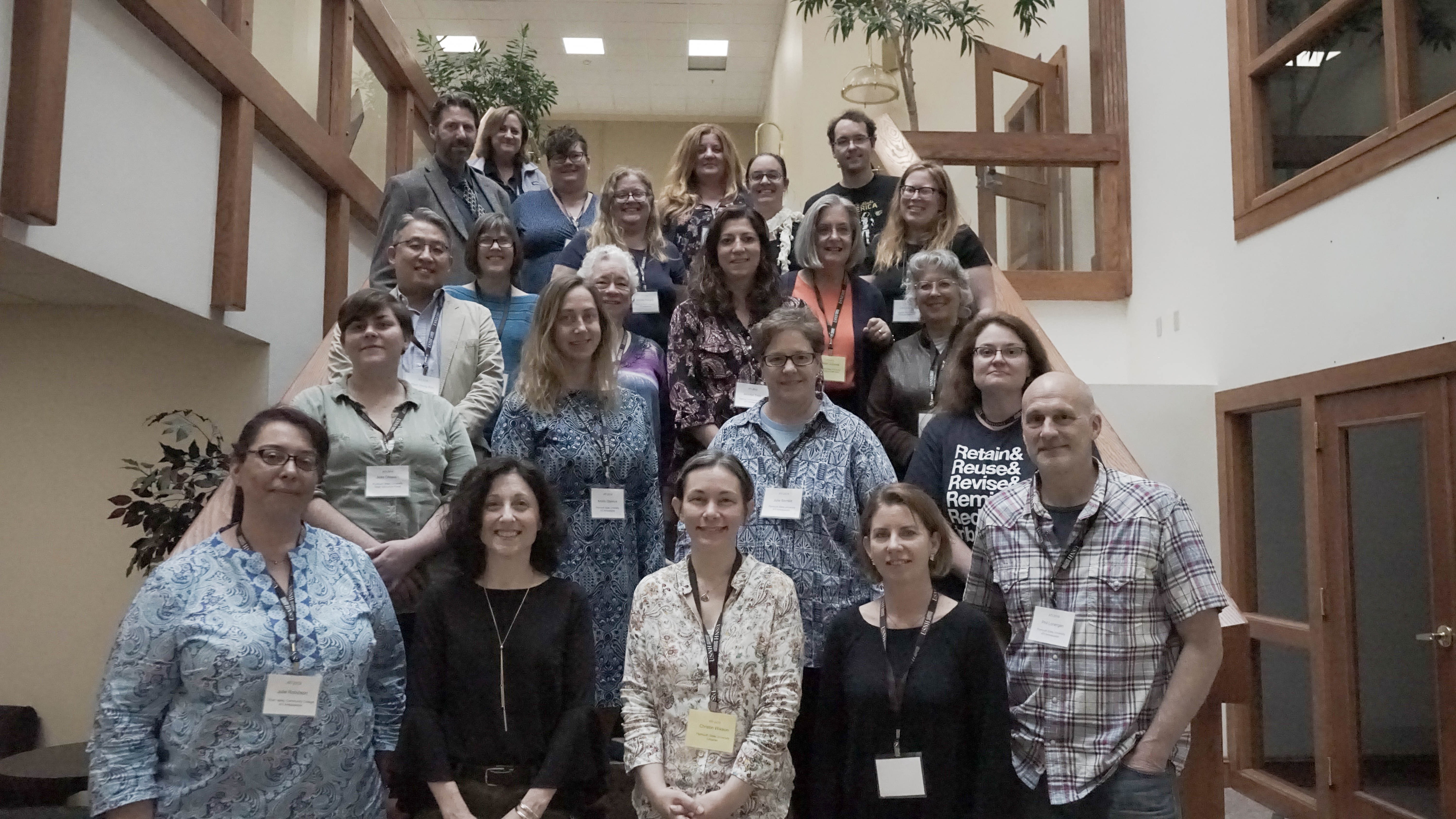 Some of the USNH and CCSNH participants on a stairway at Granite State College posing for the camera