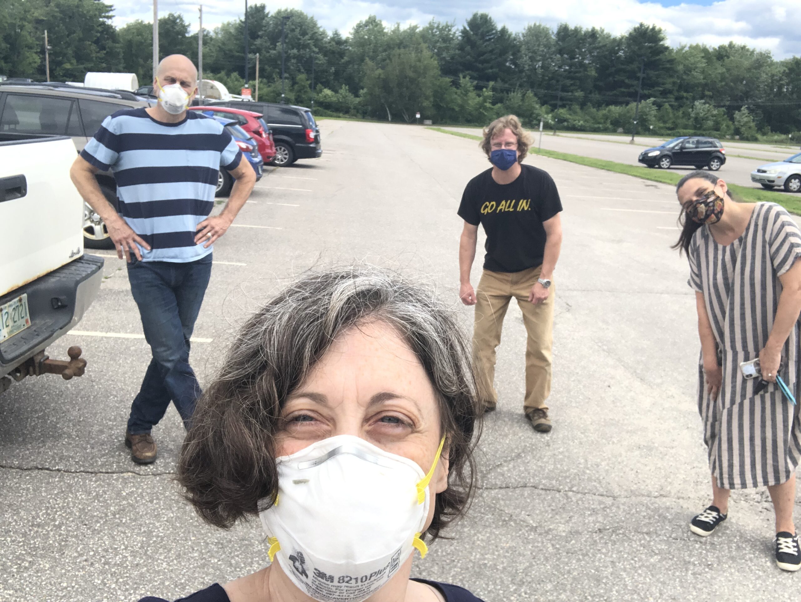 Robin and Martha posing with friends in parking lot