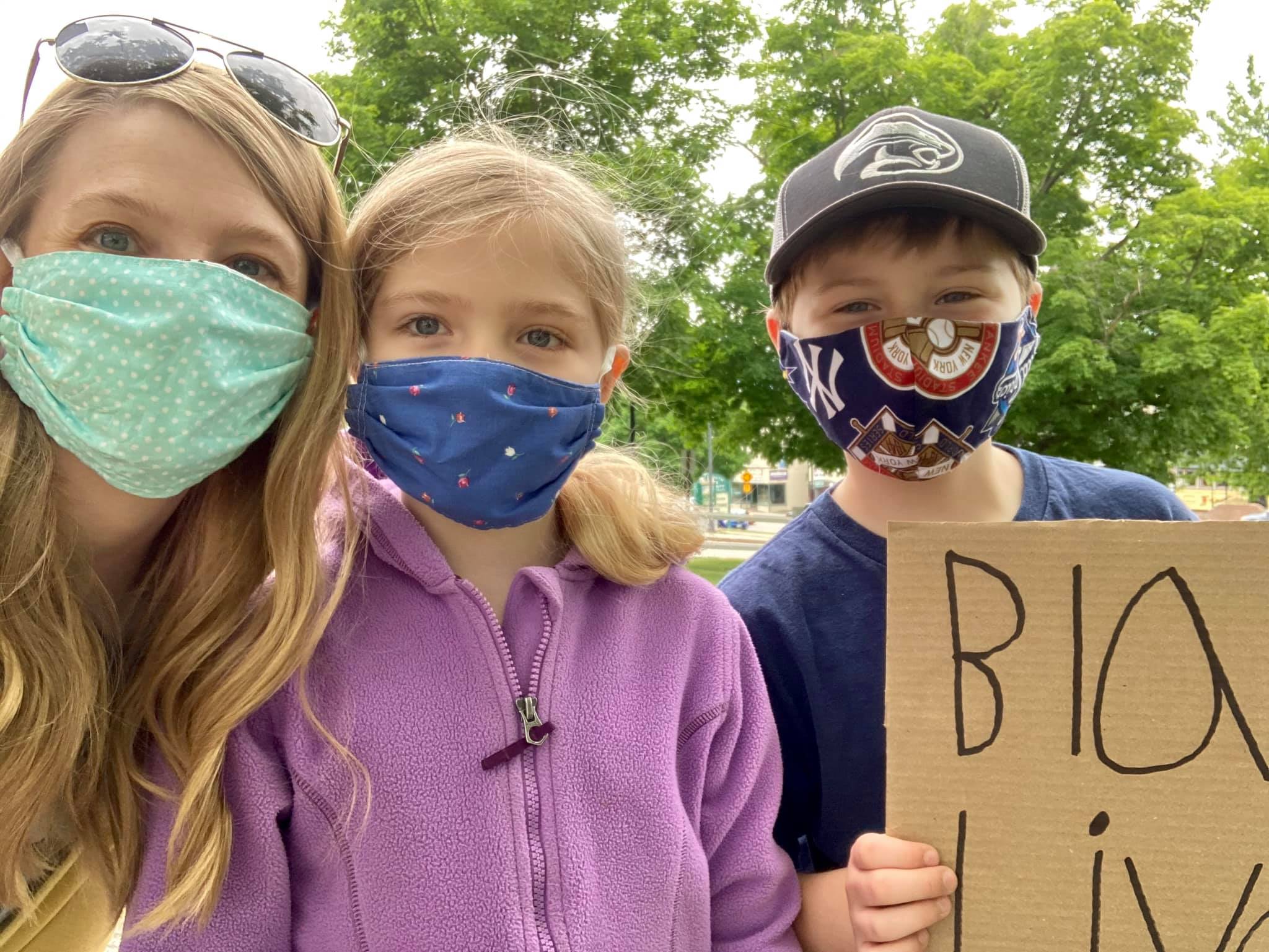 Mother taking selfie with two children