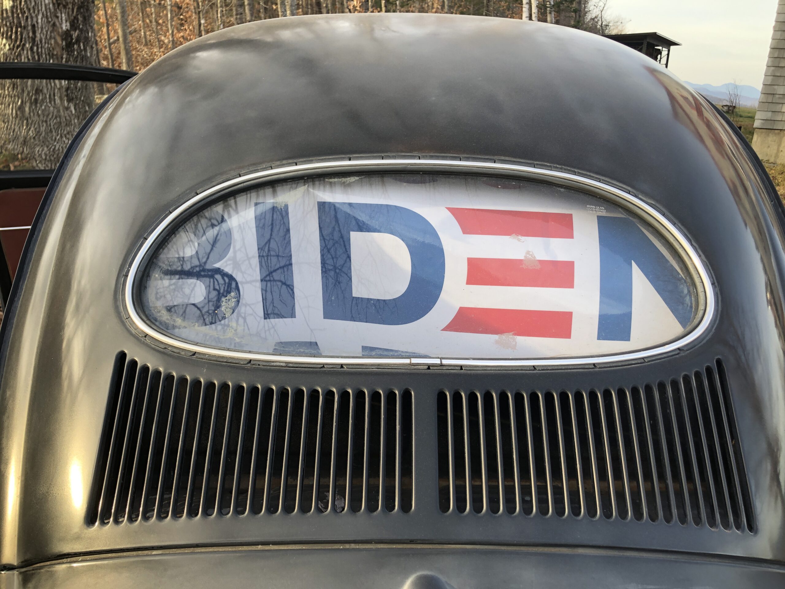 Biden sign in back window of antique car
