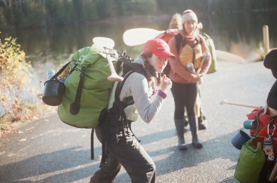 smiling woman with a thumbs up and a big hiking backpack