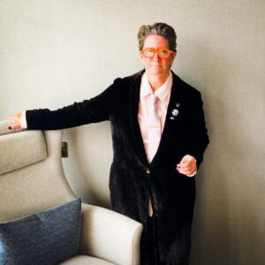 White female-presenting person with short hair and glasses