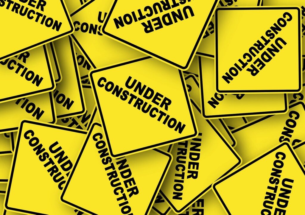under construction signs in a pile